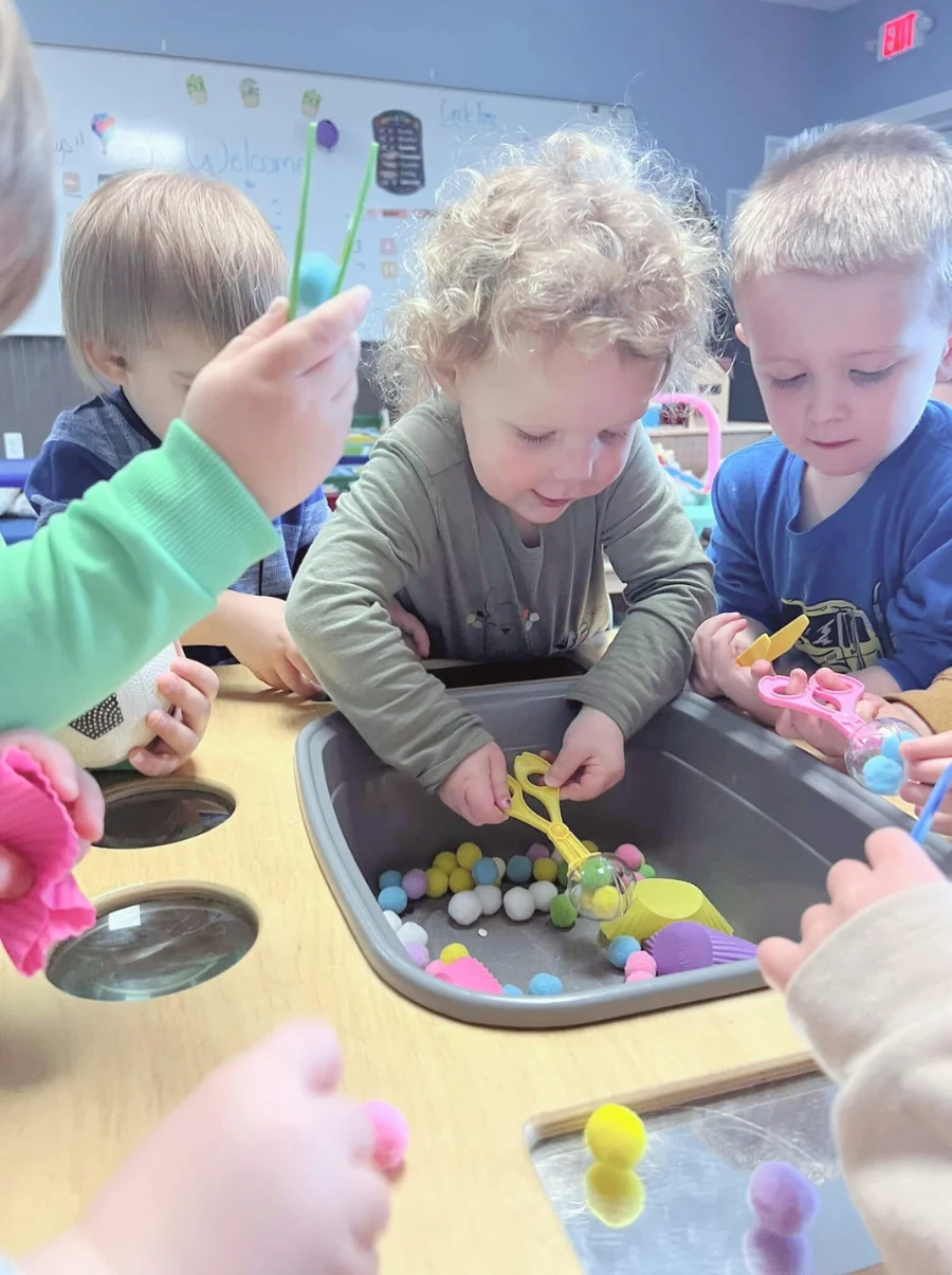 Toddler-2 Toddlers playing in a plastic sink.